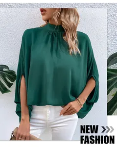 Detail of dark green mock neck blouse with unique split long sleeves and elegant tie design