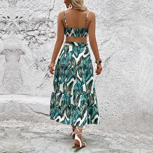 Two-piece summer set with tropical green leaf print featuring a crop top and maxi skirt