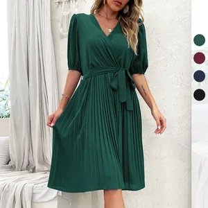 Elegant V-neck pleated dress in dark green with puff sleeves and a waist tie belt