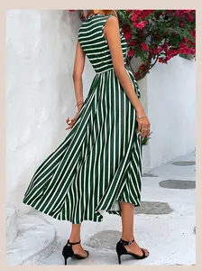Detail of green and white striped sleeveless dress featuring vertical striped skirt hem