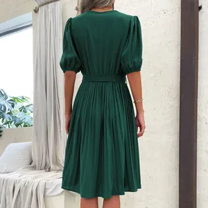 Women's dark green pleated midi dress with puff sleeves and tie waist, back view design