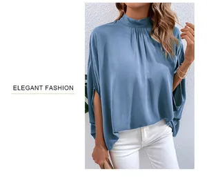 Detailed view of the elegant blue high-neck blouse with pleated collar and silky texture