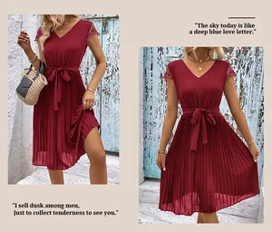 Detail of burgundy pleated dress featuring delicate lace sleeves and waist tie detail