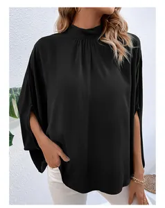 Detail of elegant black mock neck shirt with chic split cape sleeves and draped fabric