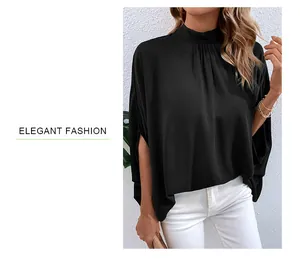 Detail of elegant black mock neck shirt with wide sleeves and premium draped fabric