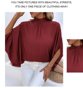 Detail of high-neck pleated chiffon blouse in wine red with stylish batwing slit sleeves