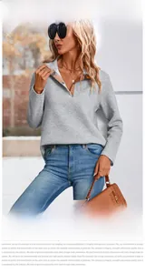 Detail of grey quilted texture sweatshirt featuring a buttoned Henley collar and plaid lining