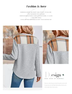Detail of grey waffle textured fabric with plaid patchwork and curved hemline on sweatshirt