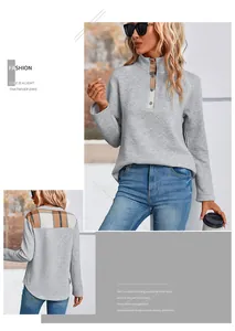 Detail of grey quilted sweatshirt featuring brown plaid patchwork on collar and back