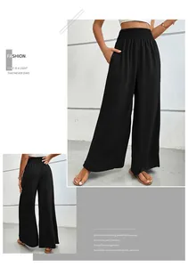 Détail de la taille élastique haute sur un pantalon large plissé noir fluide