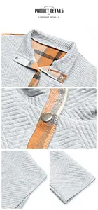 Detailed shot of quilted grey fabric with orange plaid lining and metal snap buttons