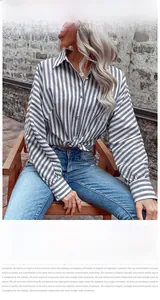 Detailed close-up of blue striped long sleeve shirt with front tie knot hem and collar