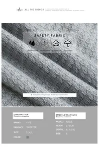 Detail of grey waffle knit texture and fabric features with model size specifications