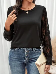 Detail of elegant black sweatshirt featuring delicate lace patchwork sleeves and ribbed cuffs
