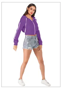 Detail of purple cropped zip-up hoodie with white sleeve stripes and studded denim shorts