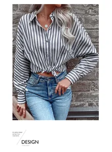 Detail of blue striped button-down shirt featuring a stylish front-knot hem design