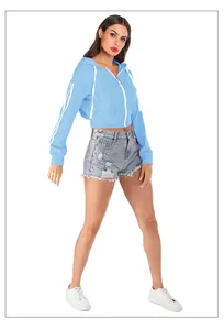 Detail of light blue cropped hoodie with white sleeve stripes and metal ring zipper
