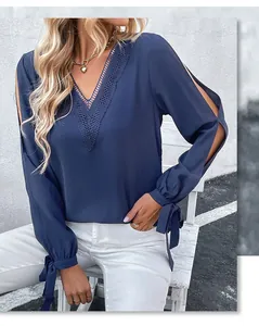 Detail der marineblauen V-Ausschnitt-Bluse mit Spitzenbesatz und modischen Bindebändern