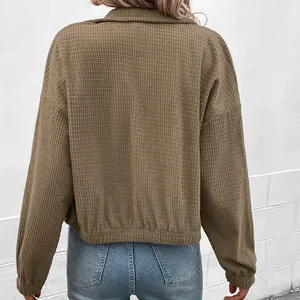 Back view of a women's khaki waffle knit cropped jacket with a stylish stand collar