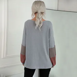 Women's long sleeve waffle knit sweater with grey color block design from a back view