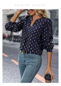 Detail of V-neck long sleeve blouse with gold diamond pattern and chic puffed cuffs