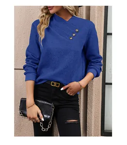 Close-up of asymmetrical V-neck with vintage buttons on blue diamond-textured sweatshirt