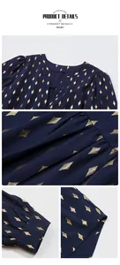 Detail of V-neckline and gold geometric diamond patterns on navy long-sleeve blouse