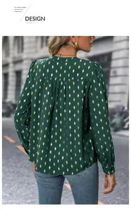 Detail of dark green blouse featuring gold diamond patterns and back pleat design