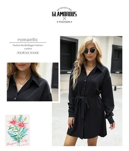 Détail d'une robe chemise noire à manches longues avec col à revers et ceinture nouée