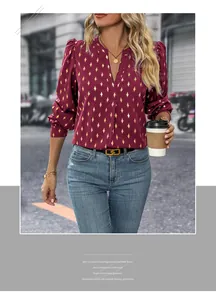 Detail of burgundy long sleeve V-neck shirt with gold diamond pattern and lantern sleeves