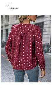 Detail view of burgundy long sleeve blouse with gold diamond pattern and pleated back