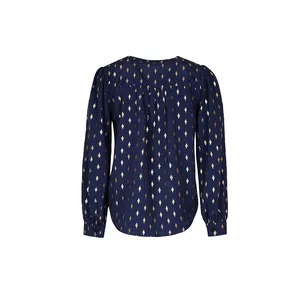 Detailed view of women's navy blouse featuring golden diamond patterns and pleated back