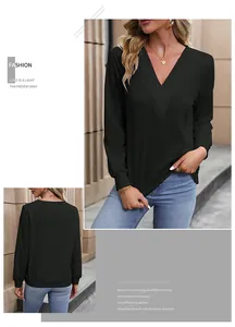 Detail of a casual black V-neck long sleeve top showing its relaxed fit and soft fabric texture