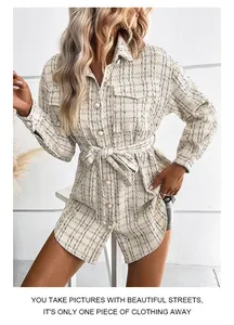 Close-up of beige tweed plaid jacket showing pearl buttons and textured fabric detail