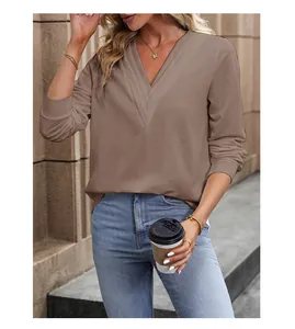 Close-up of deep V-neckline and high-quality khaki fabric on women's long sleeve top