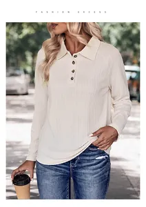 Close-up of textured knit fabric on a cream polo shirt with three brown buttons