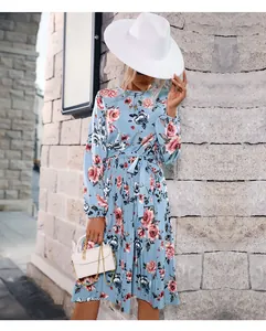 Detail of light blue floral pleated dress with waist tie and delicate flower pattern