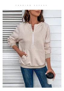 Detailed view of beige quilted waffle hoodie with half-zip collar and front kangaroo pocket