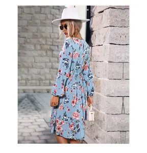 Detail of light blue floral dress showing long lantern sleeves and cinched waist belt
