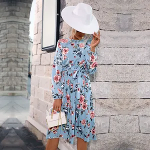 Elegant light blue pleated midi dress with floral print and waist tie detail