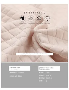 Detailed macro view of pink waffle knit hoodie fabric showing breathable texture and stitching