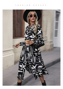 Detail of black and white abstract print on a long-sleeved shirt dress with belted waist