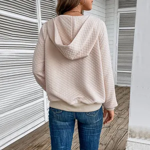 Women's quilted waffle-knit hoodie in pale apricot featuring a minimalist back view design