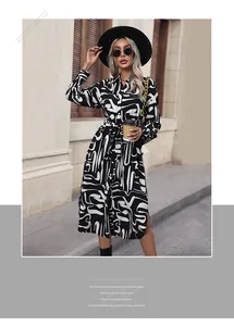 Detail of printed midi dress with abstract black and white patterns and matching waist tie
