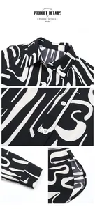 Detail view of the black and white abstract print shirt collar and button cuffs