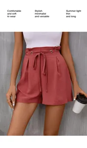Detail of high waisted brick red summer shorts with ruffle waist and tie belt design