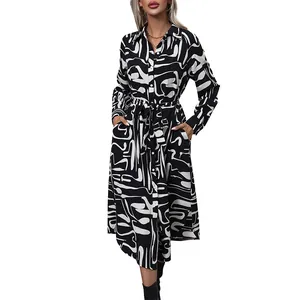Modern black and white geometric print midi shirt dress with long sleeves and belted waist