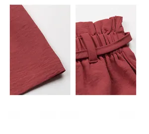 Detail of high-waisted shorts featuring elastic waist and neat hem stitching in dark red