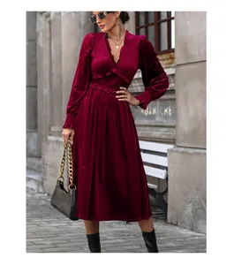 Detail of burgundy velvet dress featuring elegant ruffle trim and smocked waist design