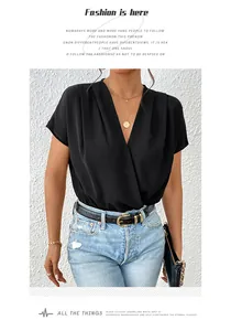 Detail of elegant black wrap V-neck bodysuit with short batwing sleeves and gold jewelry
